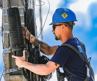 Foto de técnico realizando manutenção em rede Fibra Ótica.